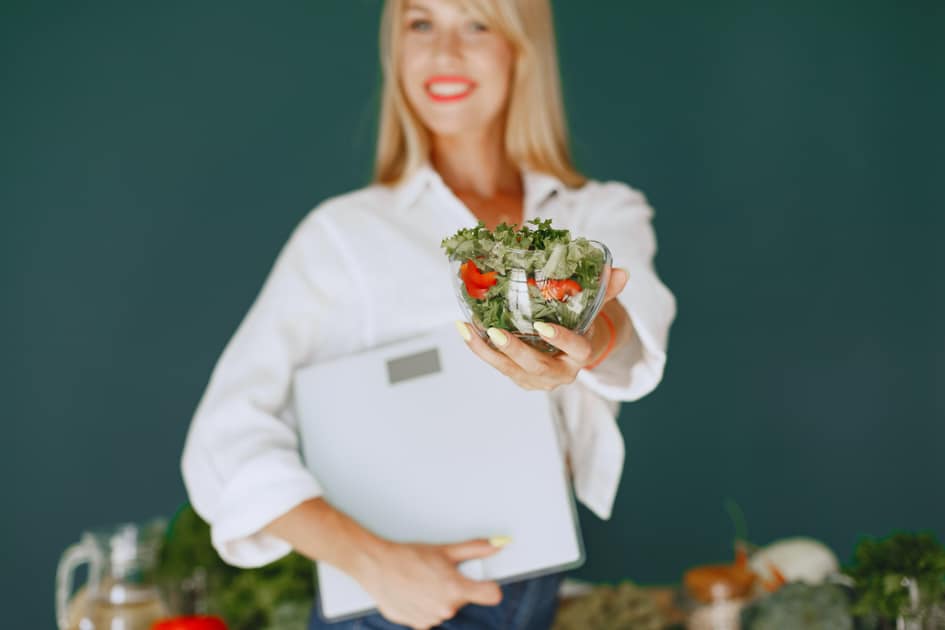 blonde dietitian holding bowl of salad