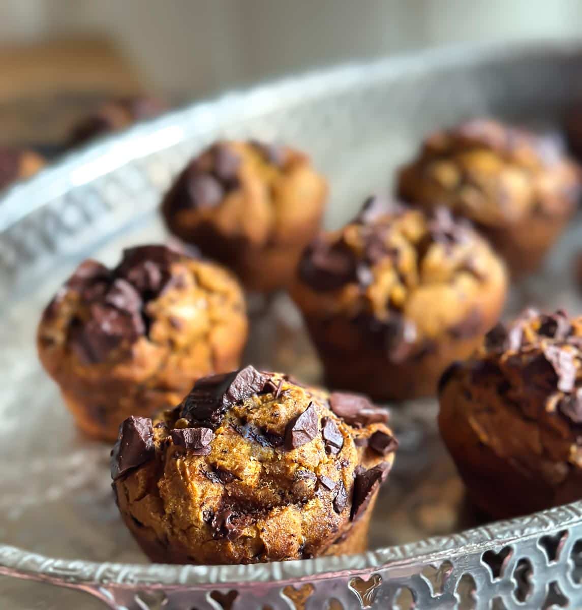 close image of low FODMAP Pumpkin Chocolate Chunk Muffins on oval silver tray