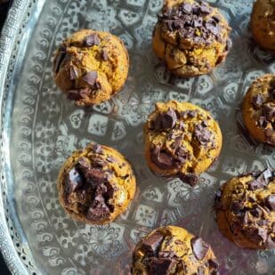 horizontal image of overhead image of low FODMAP Pumpkin Chocolate Chunk Muffins on oval silver tray