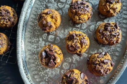 horizontal image of overhead image of low FODMAP Pumpkin Chocolate Chunk Muffins on oval silver tray