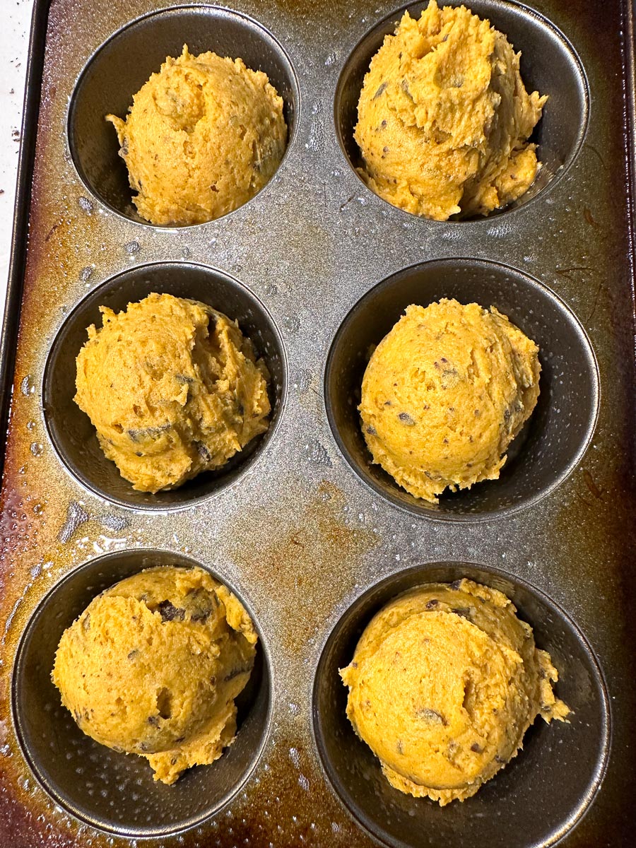 low FODMAP Pumpkin Chocolate Chunk Muffins batter scooped into muffin pans