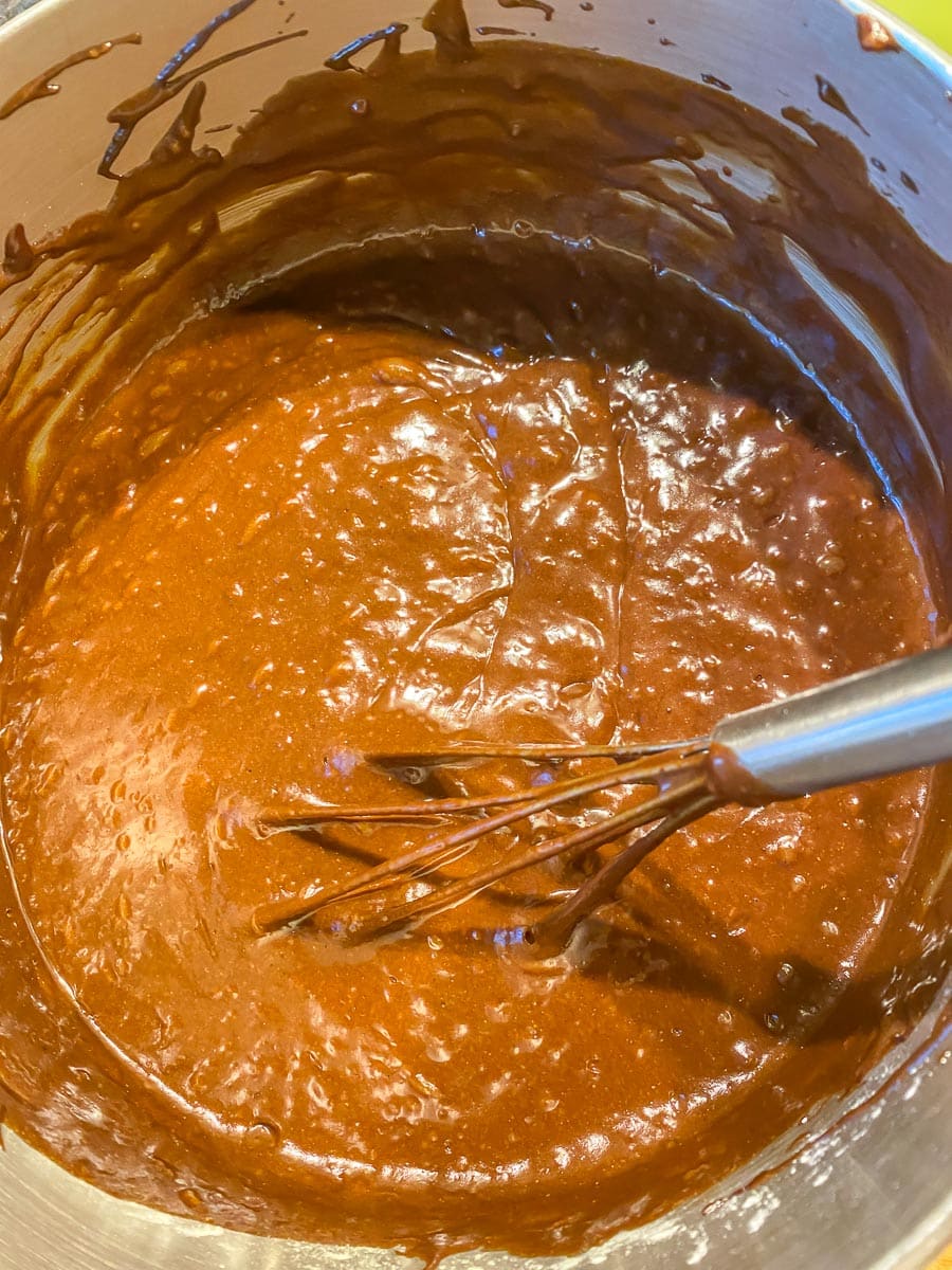 making maple mocha cake batter in bowl with whisk