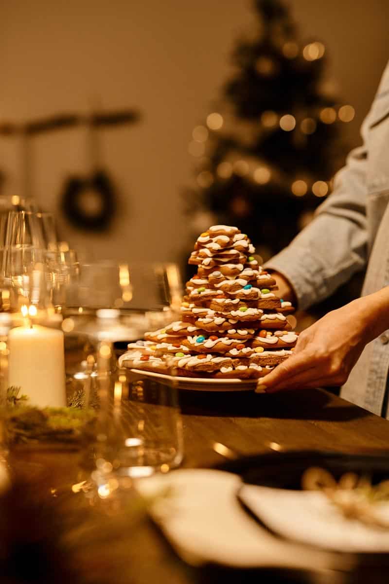 pile of christmas cookies on a plate being offered