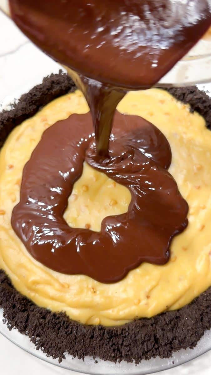 pouring ganache on top of pie