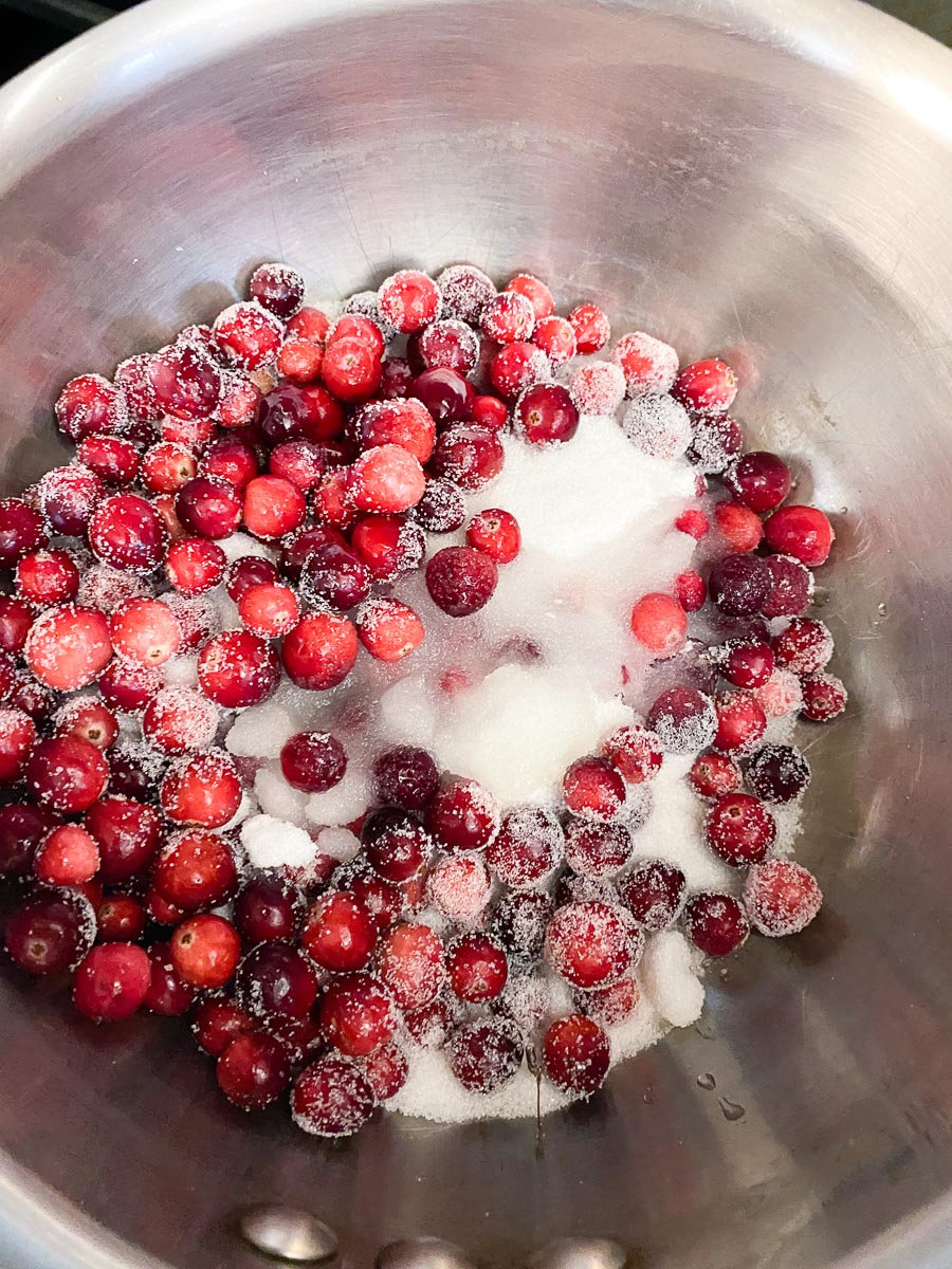 cranberries, sugar and water combined in saucepan