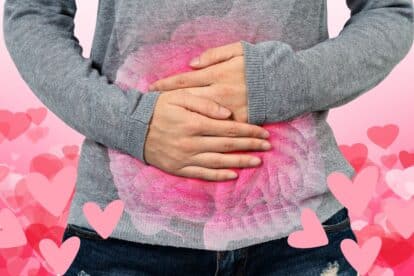 Woman holding her belly in pain with hearts floating around her