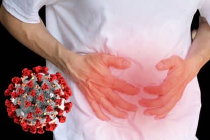 man holding his stomach in pain and a covid germ floating