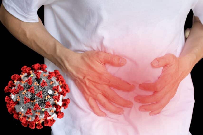 man holding his stomach in pain and a covid germ floating