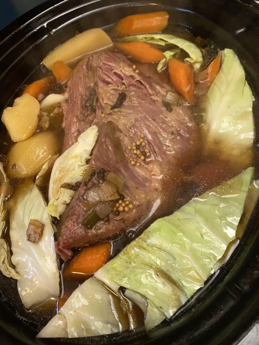 cabbage added to slow cooker with corned beef
