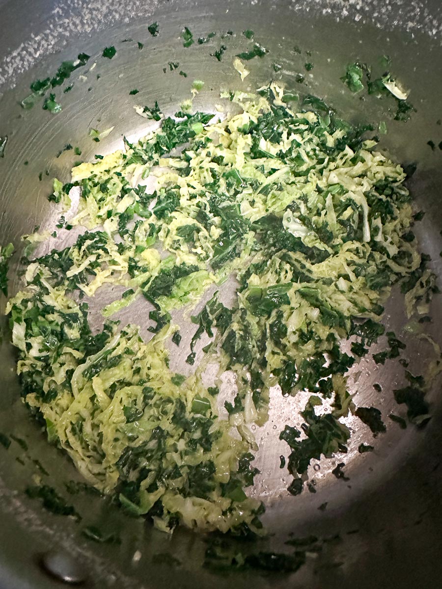 greens cooked down in pot for Colcannon