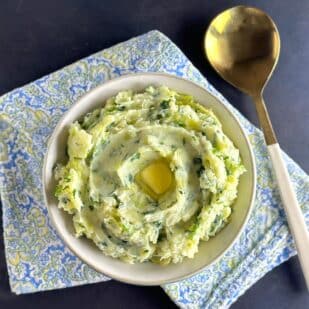 main image of Low FODMAP Colcannon in white bowl with gold spoon