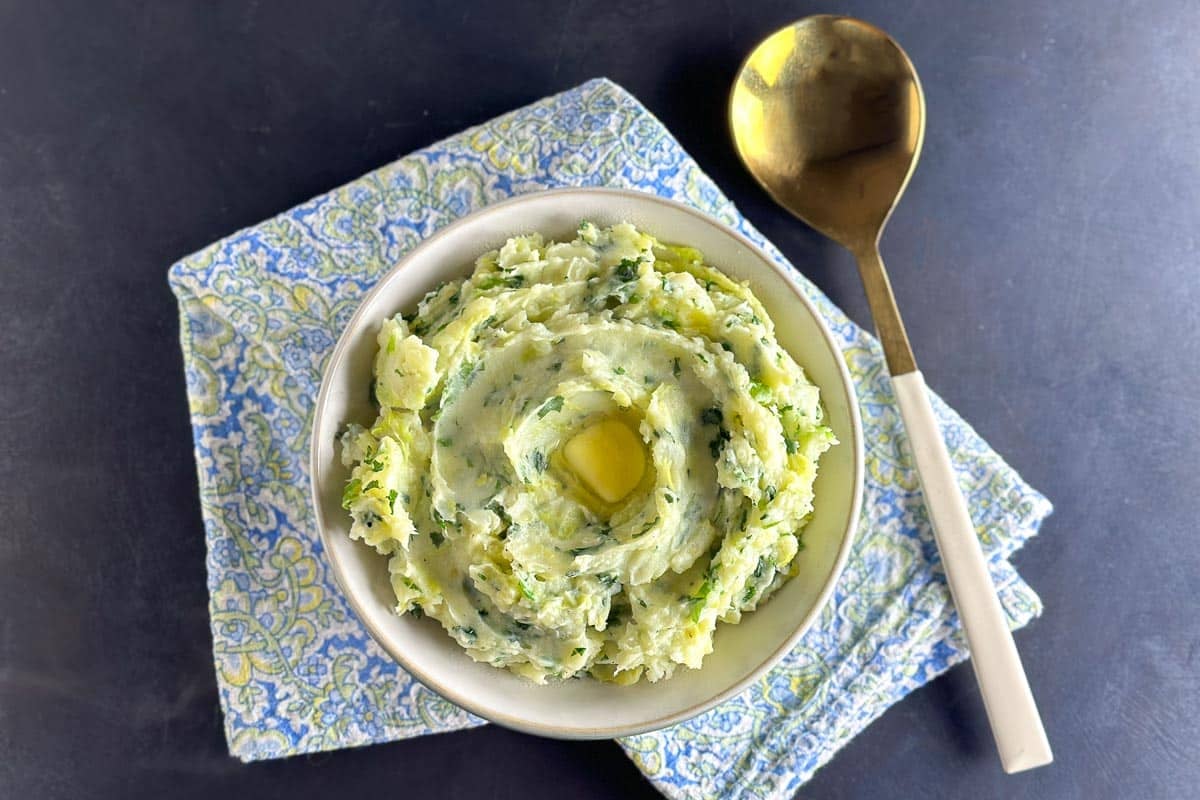 main image of Low FODMAP Colcannon in white bowl with gold spoon