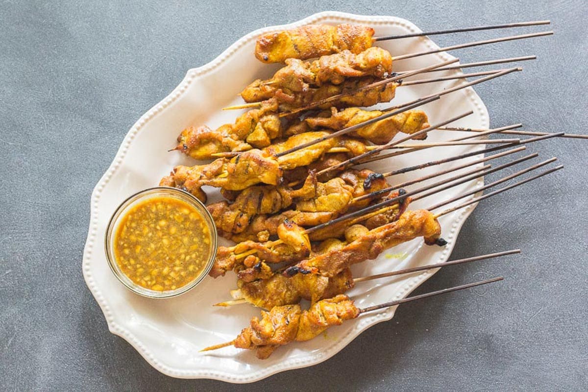 singapore-chicken-satay-on-oval-white-platter-with-dipping-sauce.