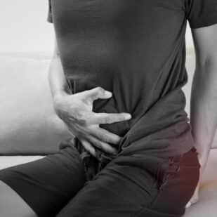 man holding stomach and butt. Gas. fart. tharakorn via 123rf