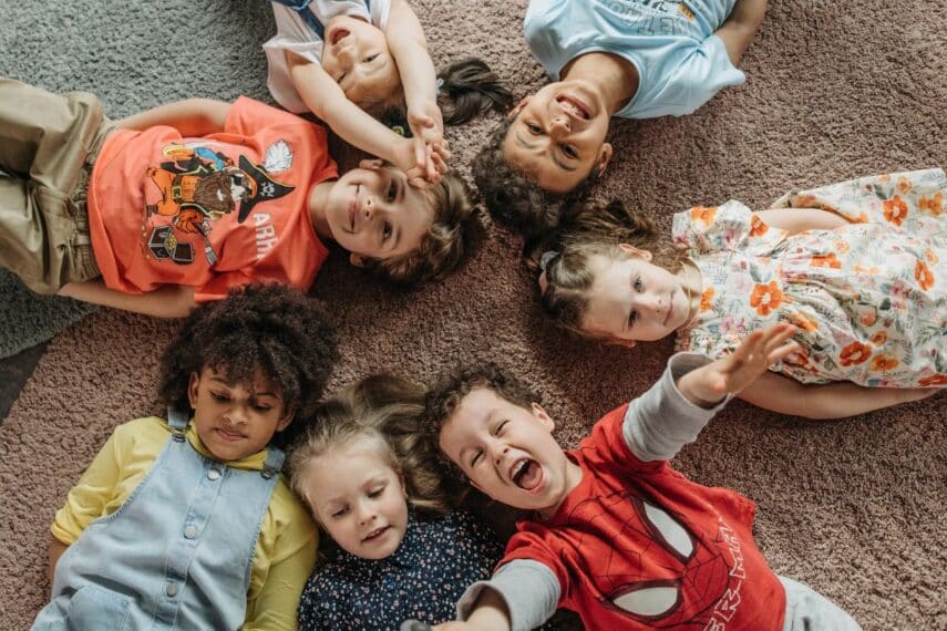 Children laying on the floor together in a circle