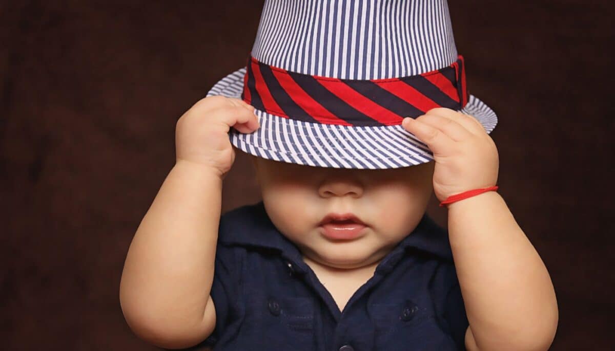 child putting a hat on