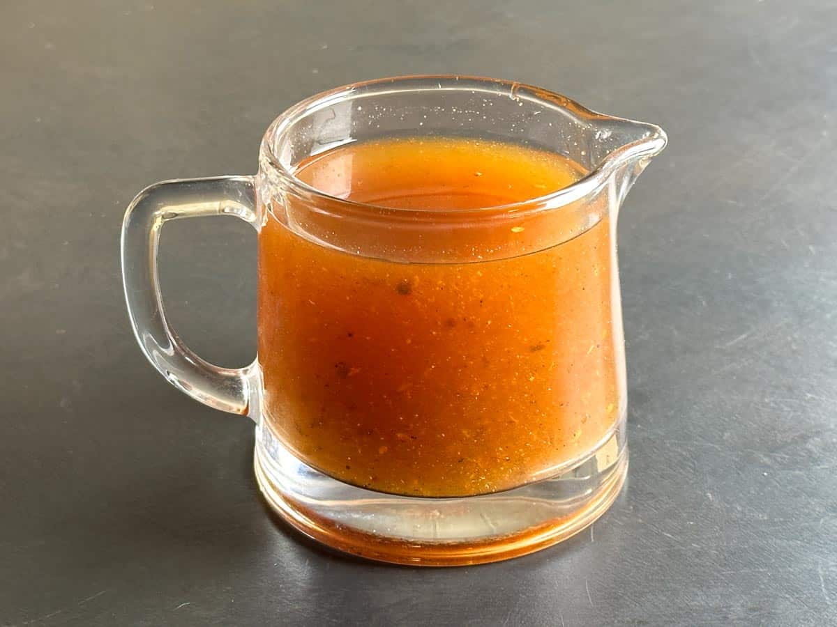 Low FODMAP Vinegar BBQ Sauce in glass pitcher.