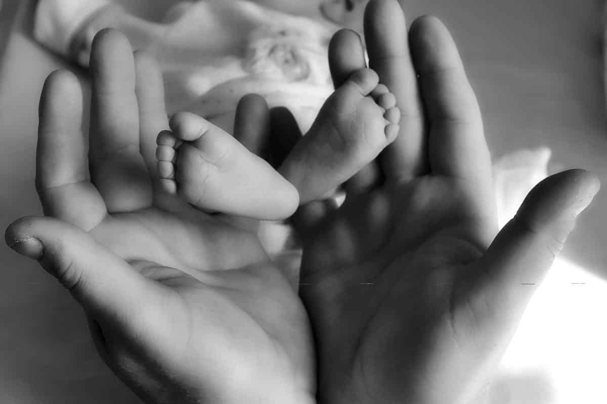 baby's feet held in hands.