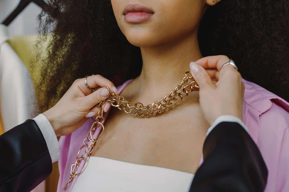 gold necklace on woman.