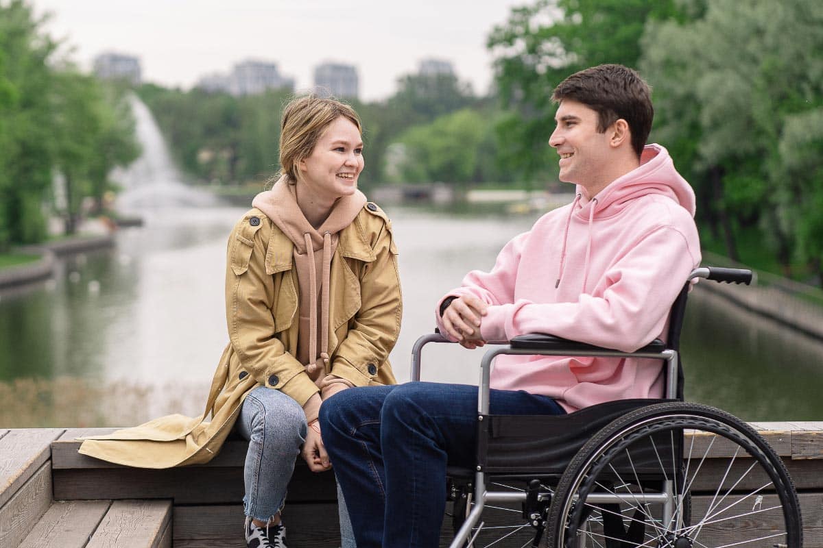 man in wheelchair with woman.
