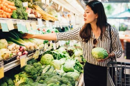 woman choosing produce.