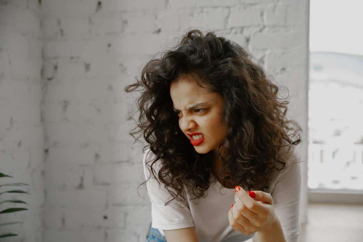 woman curly hair disgusted.