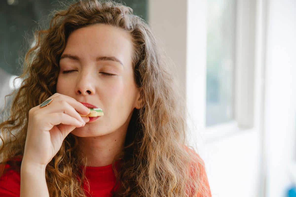 woman enjoying a cookie.