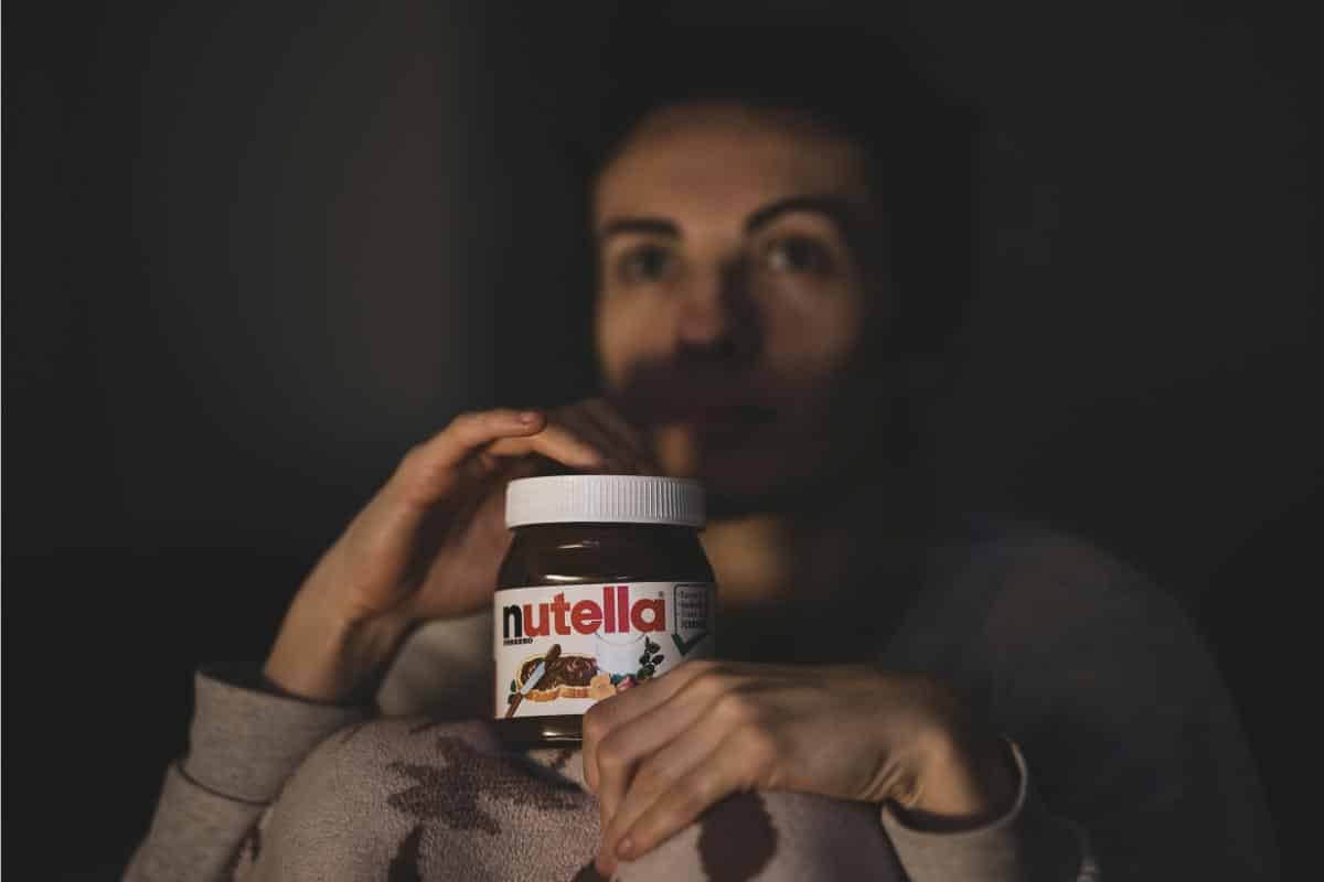 woman holding Nutella.