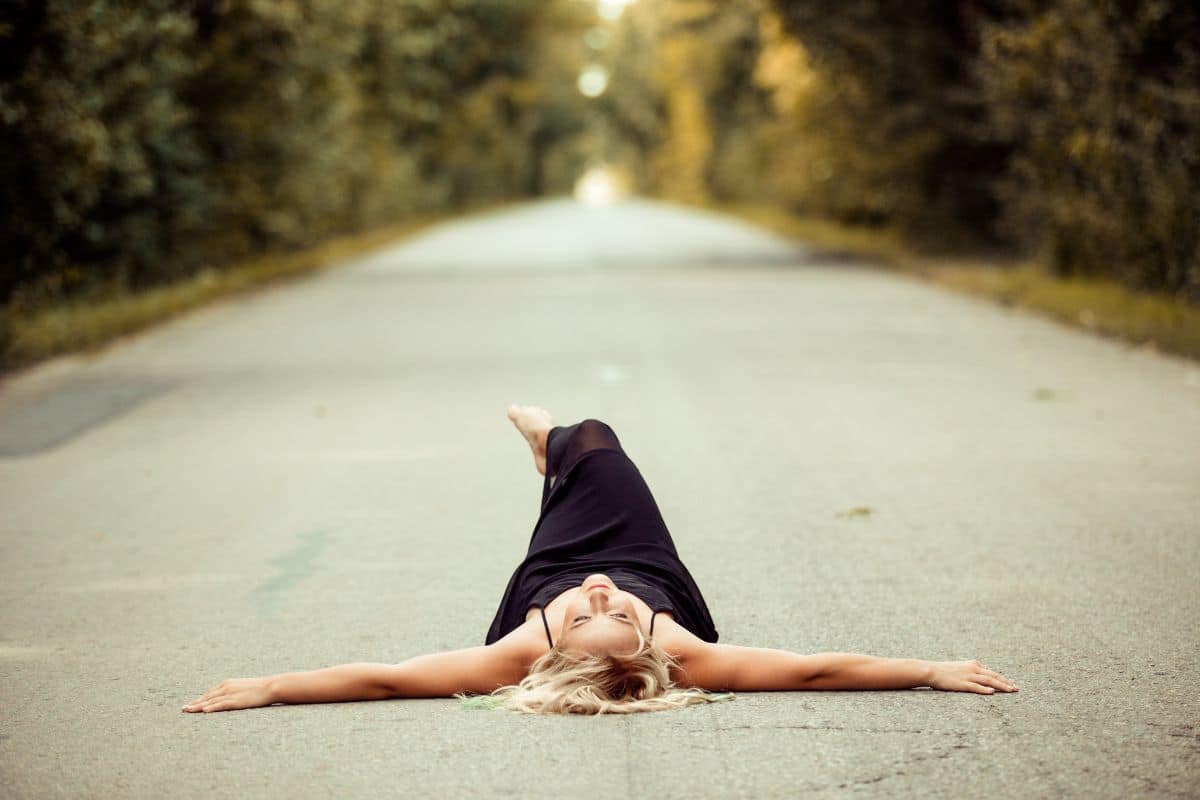 woman laying in road..