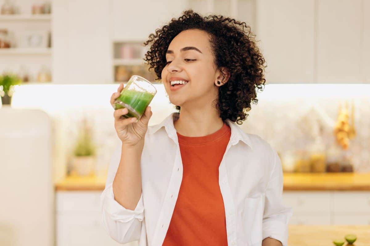 woman drinking green juice.