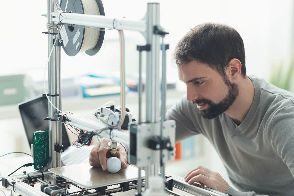 man working with 3D printer.