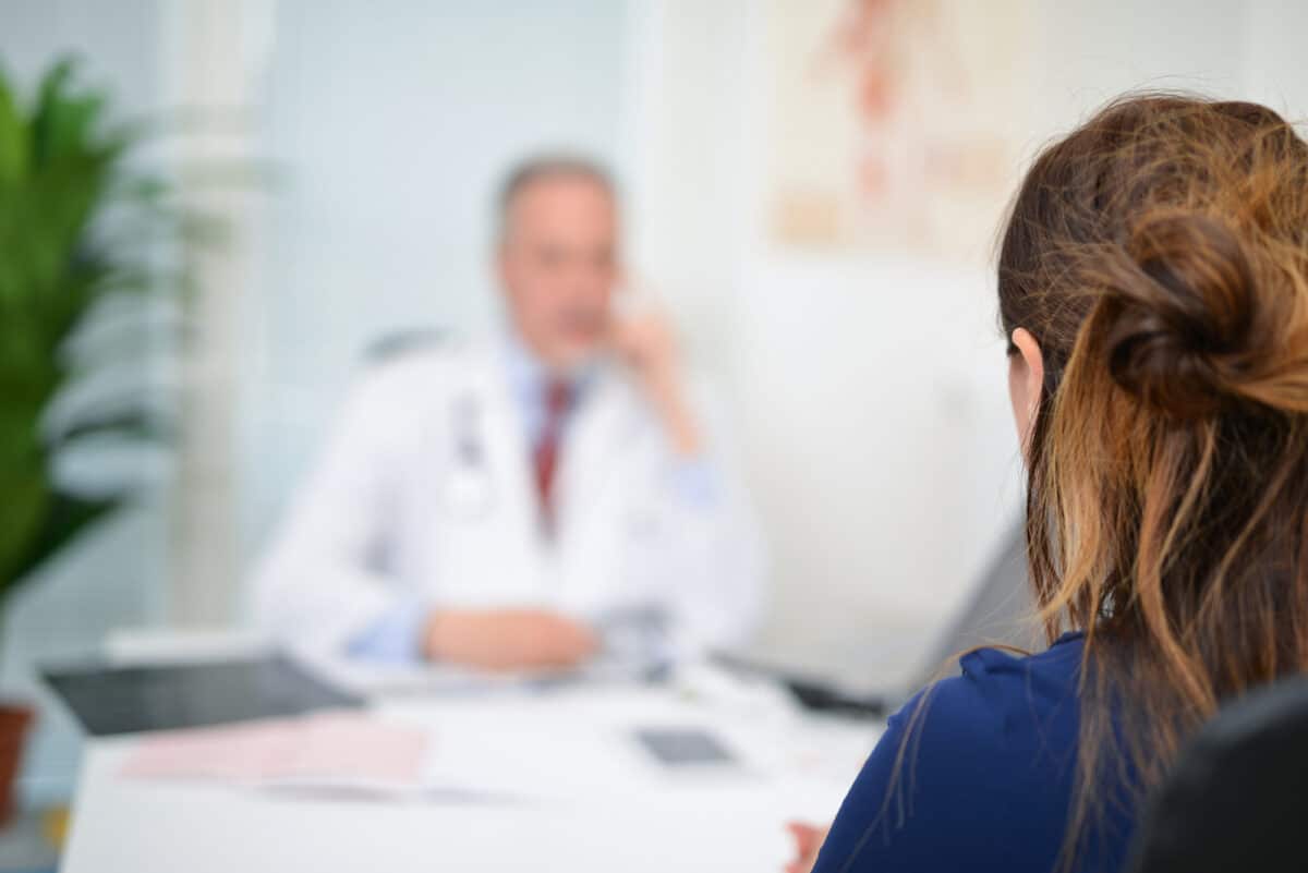 woman talking with male doctor.