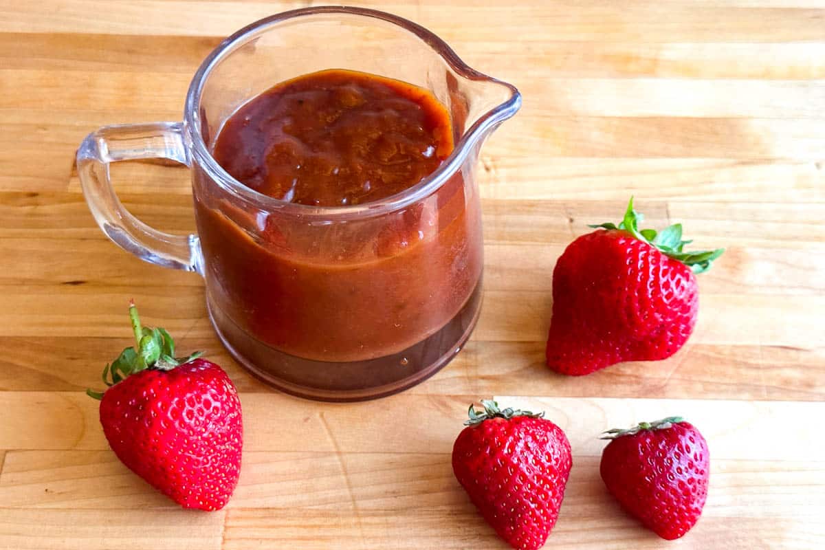 Low FODMAP Strawberry Chipotle BBQ Sauce on wooden table.