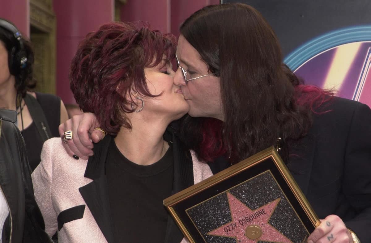 Ozzy and Sharon Osbourne kissing.