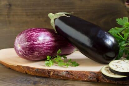Two Organic Fresh Eggplants on Wooden Background.
