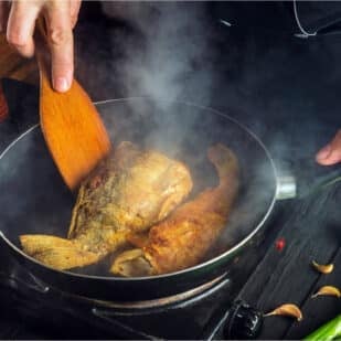 cooking fish in pan.