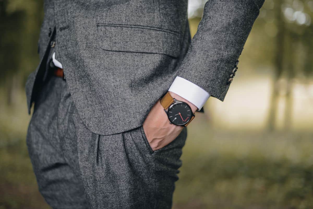 man in gray suit wearing watch.