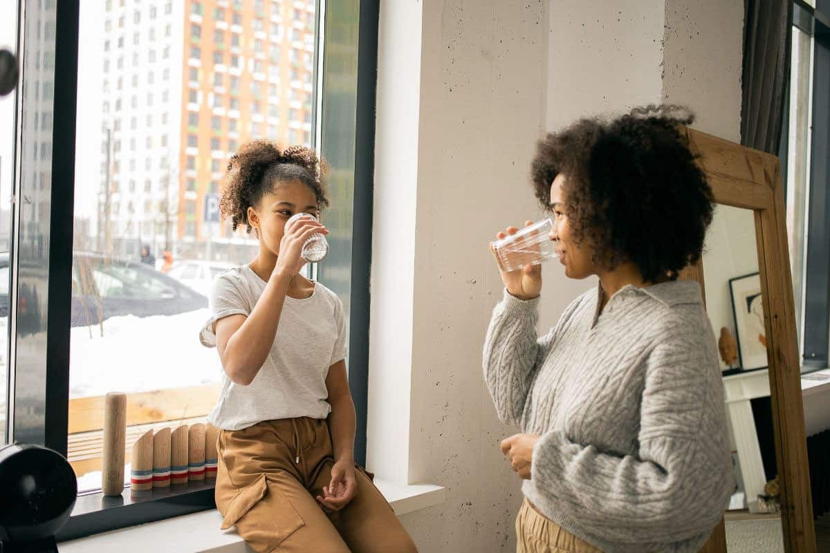 mom and daughter drinking water.