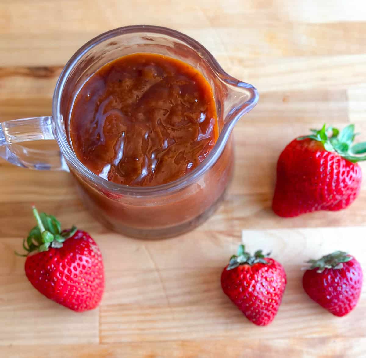 overhead image of Low FODMAP Strawberry Chipotle BBQ Sauce in pitcher.