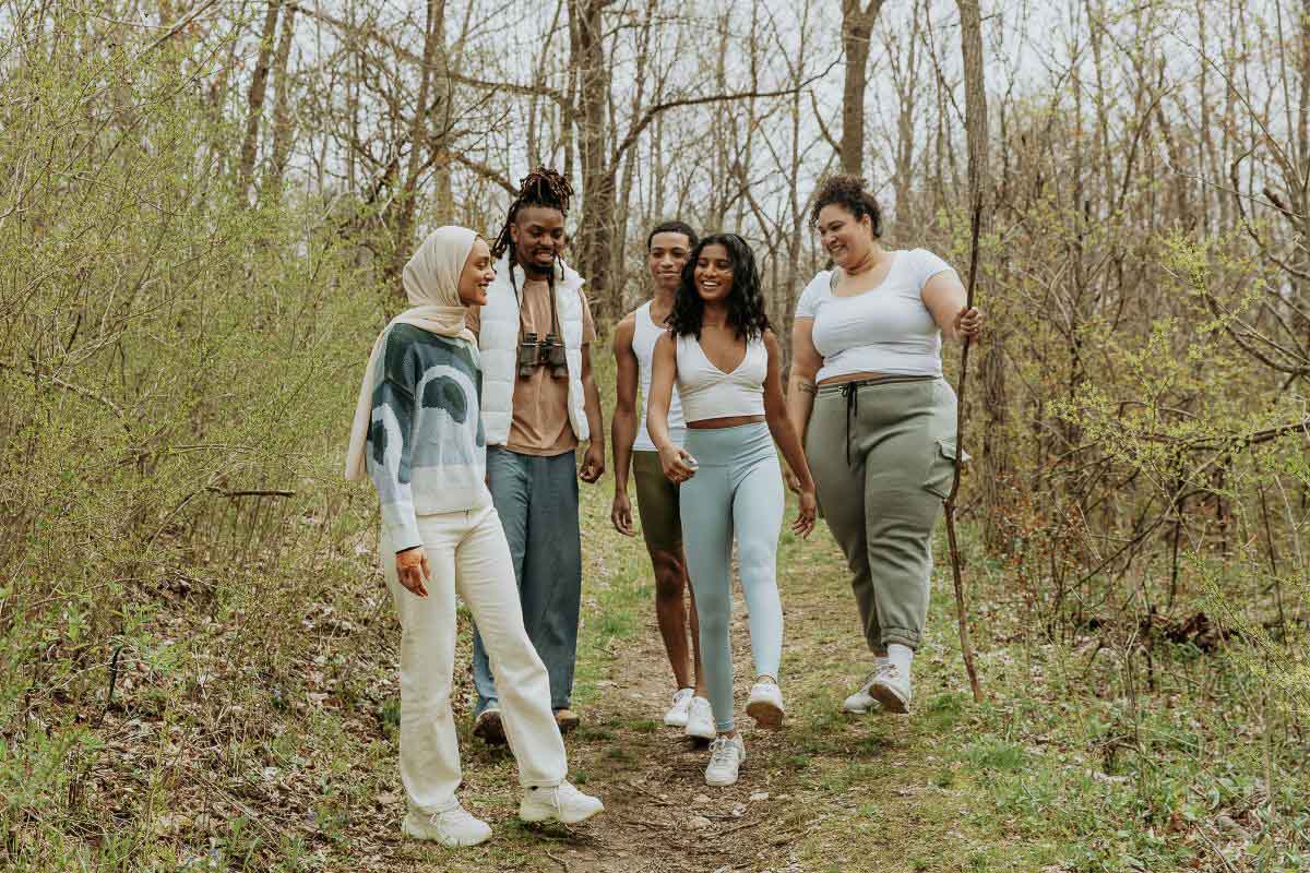 small group people walking in woods.