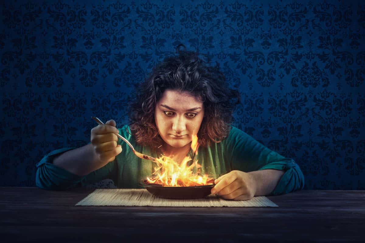 woman eating fiery food.