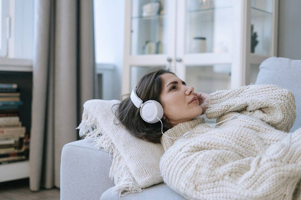 woman reclining with headphones.