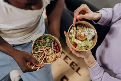 women eating healthy bowls of food.