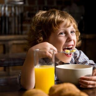 Happy Child Eating Breakfast.