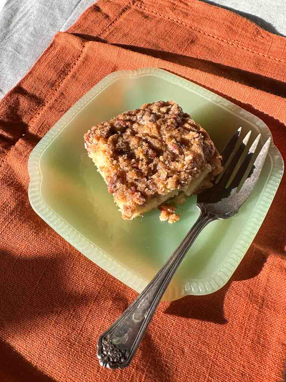 Low FODMAP Sour Cream Apple Streusel Cake square on green plate in fall sun