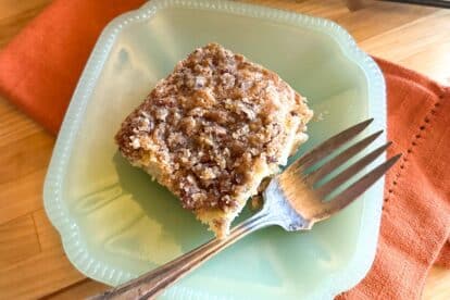 Square of Low FODMAP Sour Cream Apple Streusel Cake on green plate.