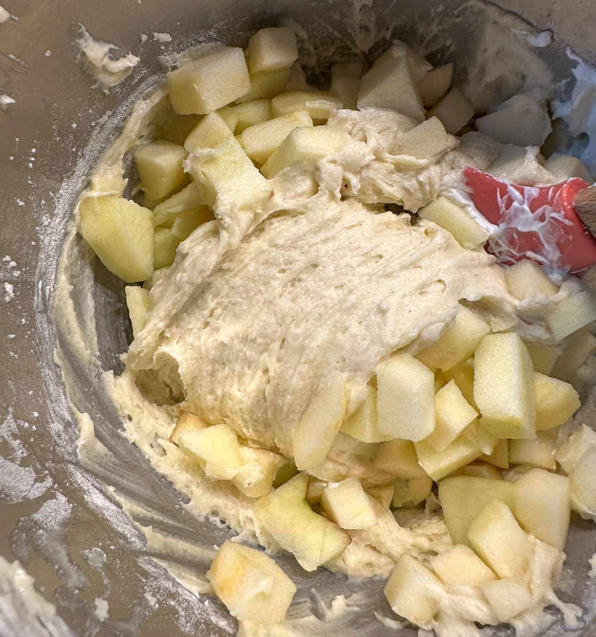 folding apples into cake batter.