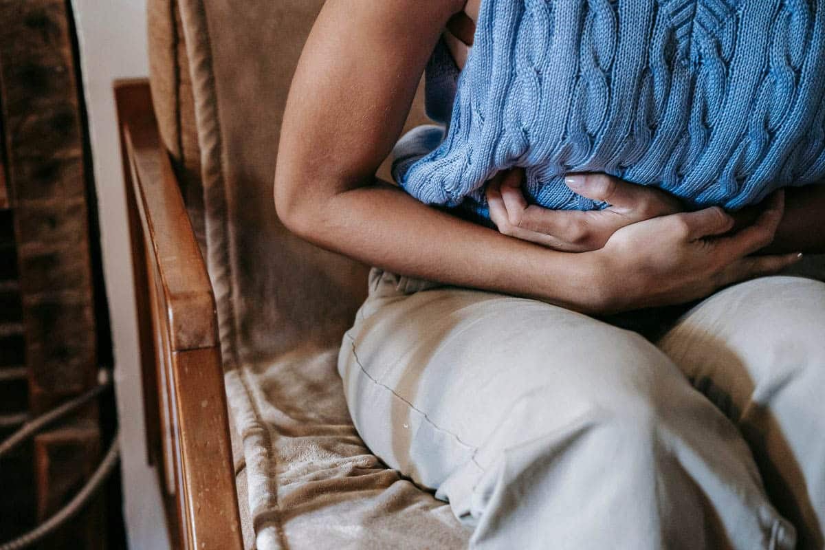 woman clutching stomach.
