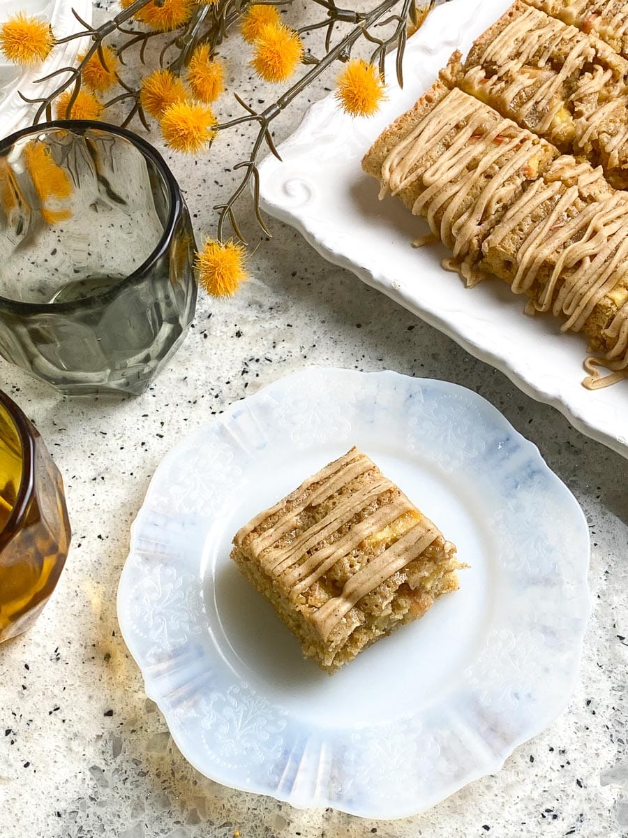 Low FODMAP Browned Butter Apple Bars with Cinnamon Maple Frosting; square on white plate.