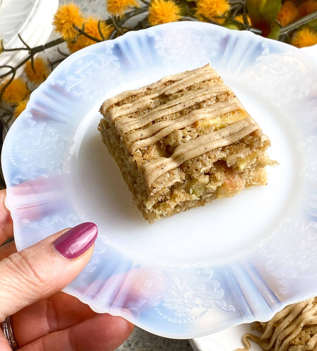 closeup of Low FODMAP Browned Butter Apple Bars with Cinnamon Maple Frosting on plate.